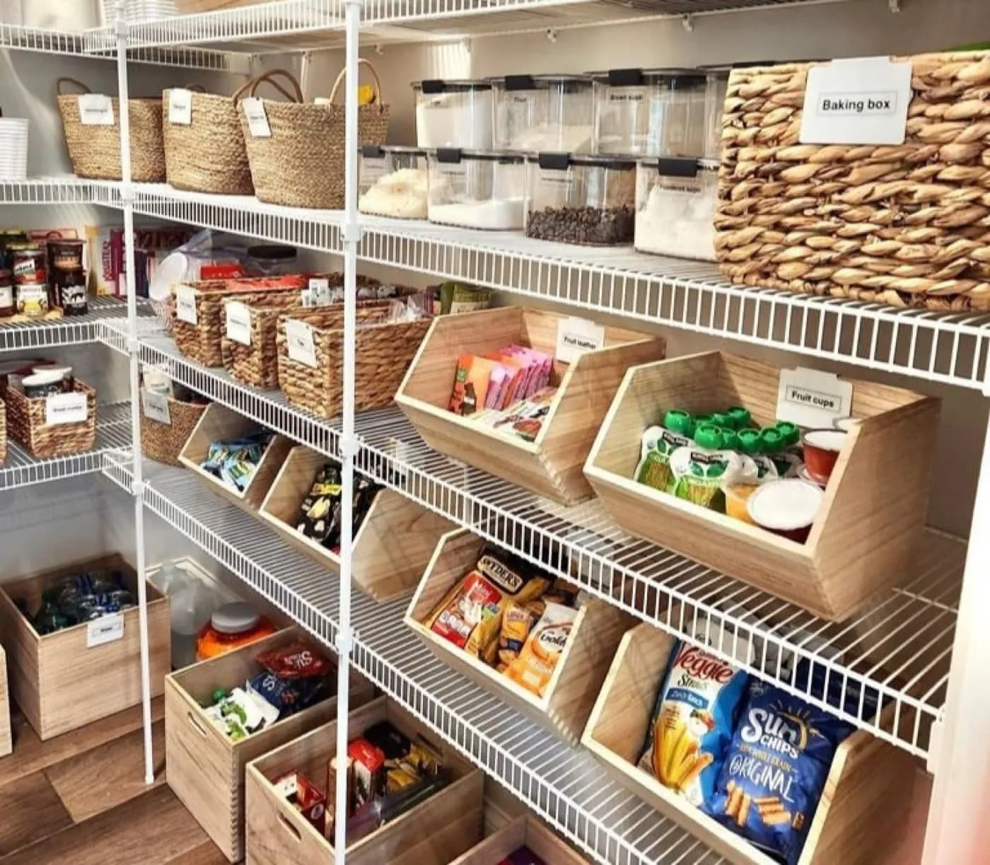 An organized family pantry with labeled baskets