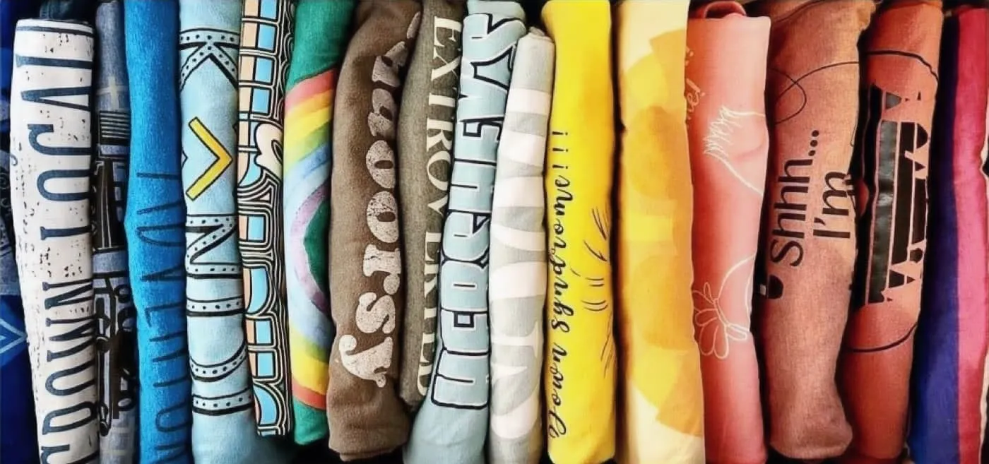 A color-sorted collection of neatly folded shirts